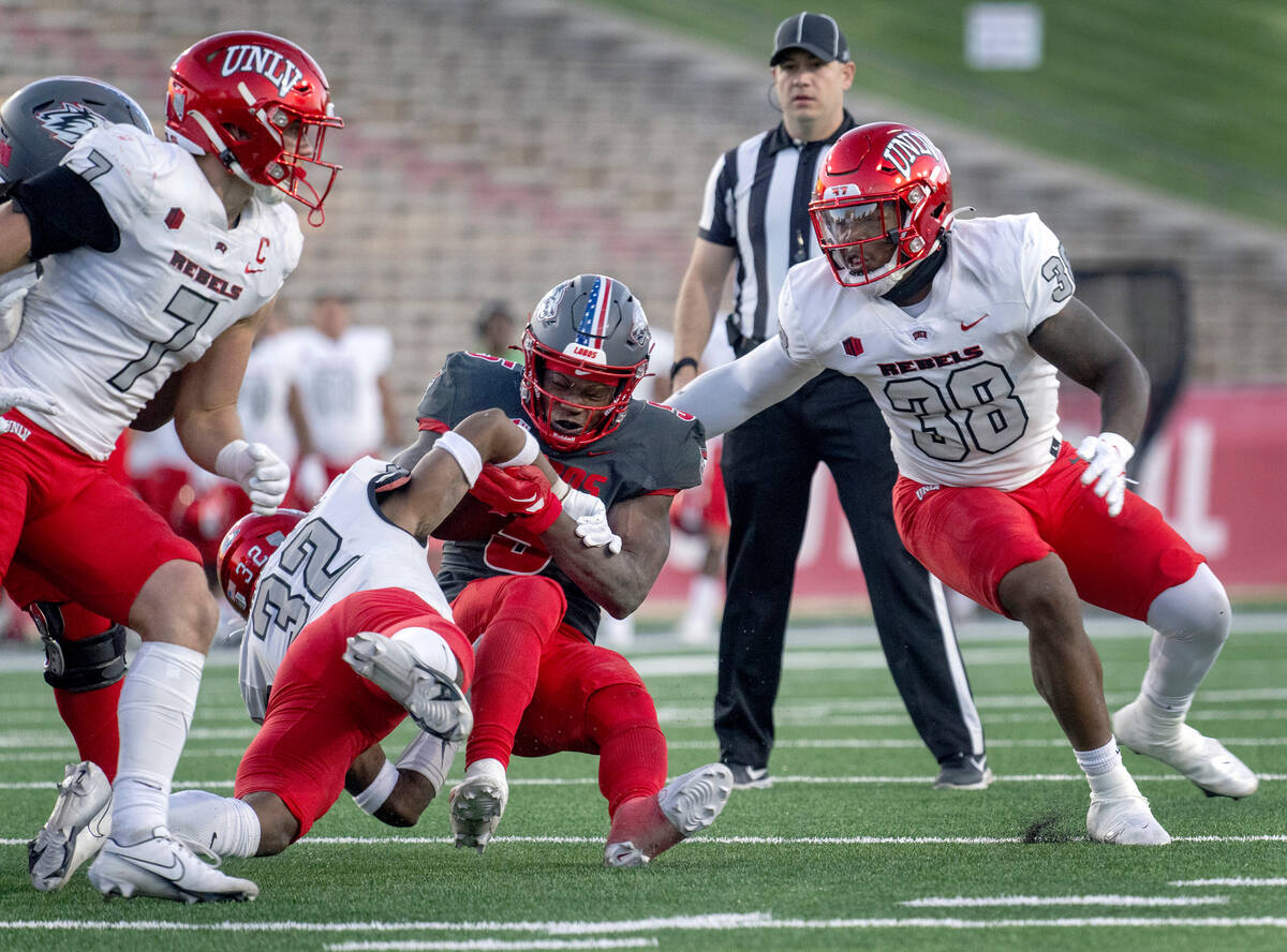 New Mexico's Jacory Croskey-Merritt (5) carries the ball close to a first down before being br ...