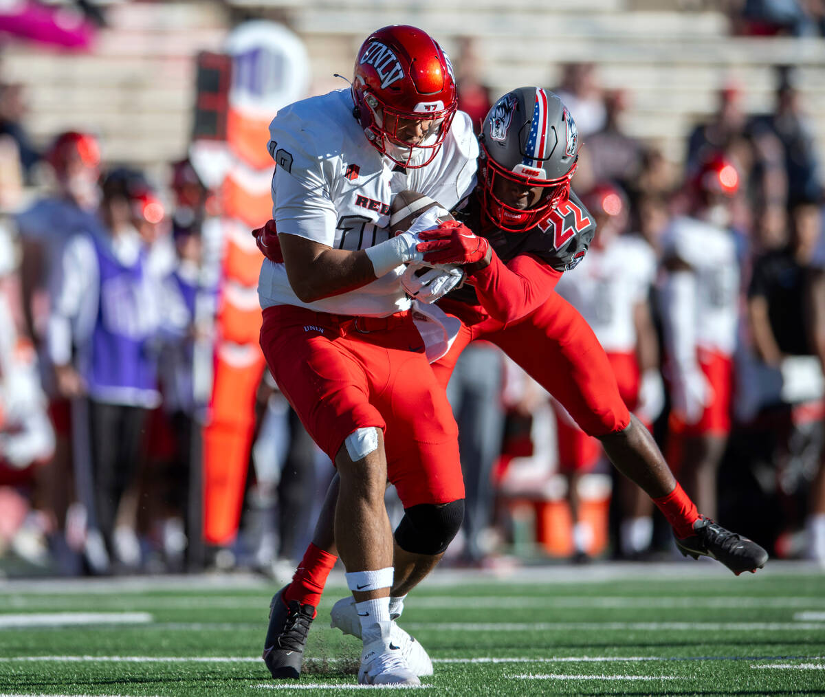 UNLV's Kaleo Ballungay, left, is tackled by New Mexico's Christian Ellis after a reception duri ...