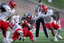 New Mexico's Jacory Croskey-Merritt carries the ball close to a first down before being brought ...