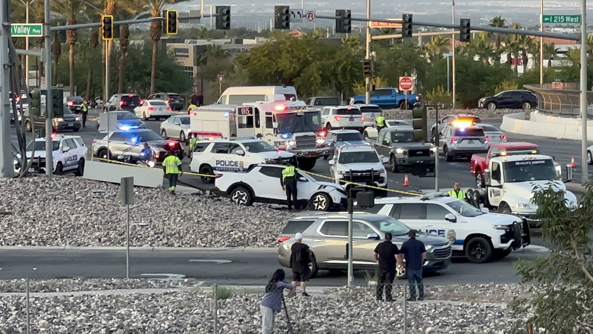 Police cars gather at the I-215 exit on Green Valley Parkway Saturday, Nov. 4, 2023, amid a pow ...
