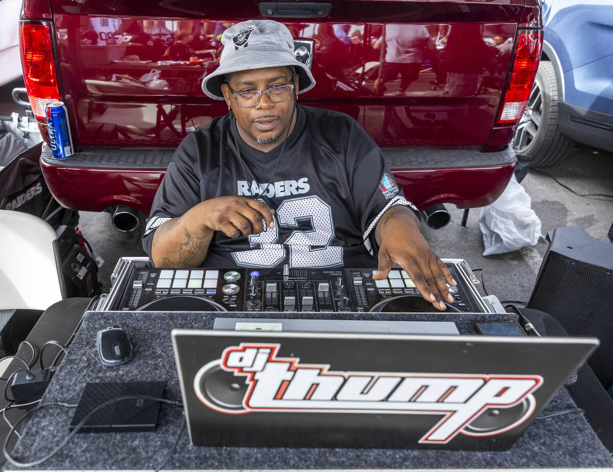 Raiders fan dj thump performs in the tailgating area before the start of the Raiders against th ...
