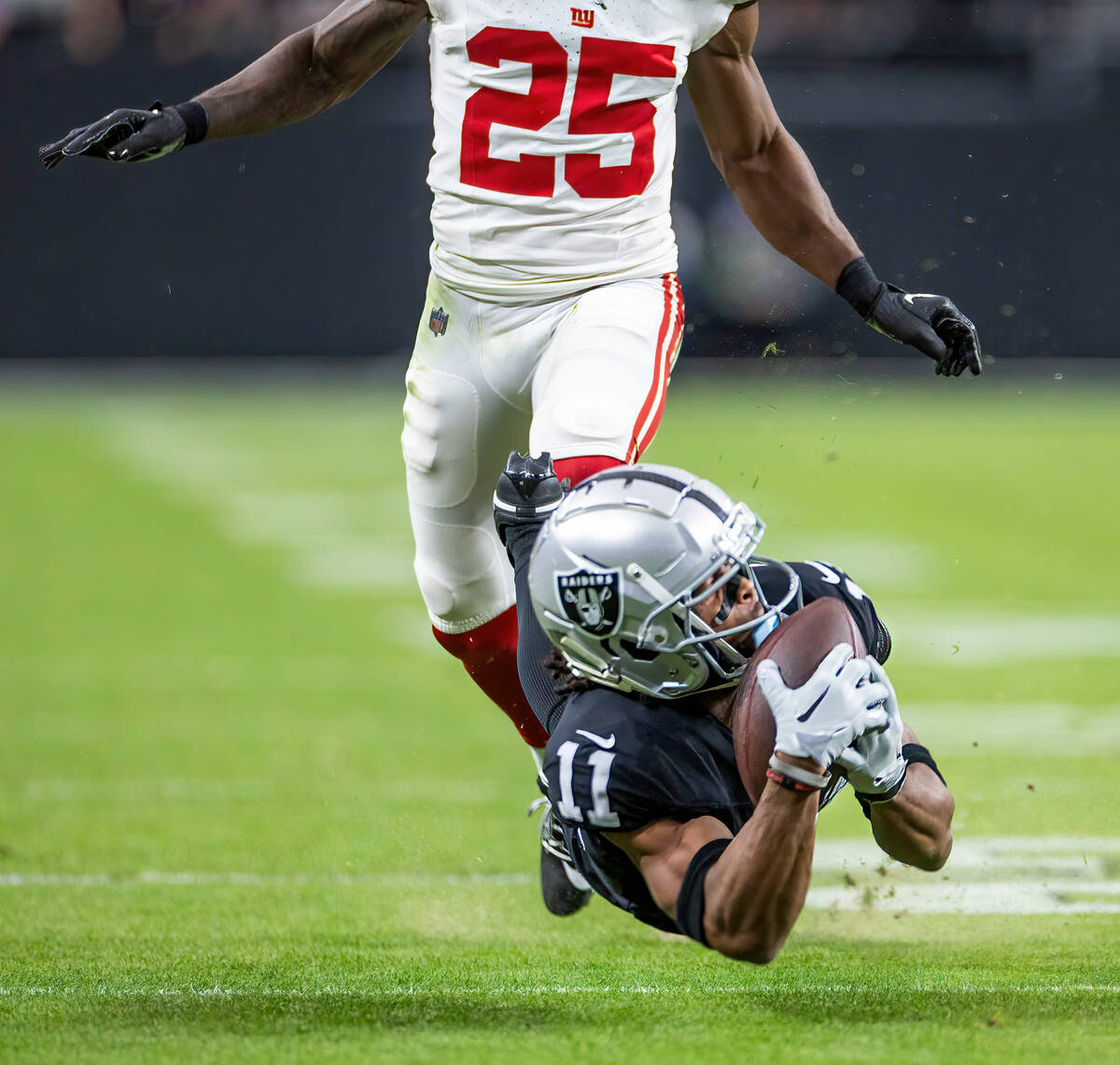 Vegas Raiders wide receiver Tre Tucker (11) catches a diving deep throw over New York Giants co ...