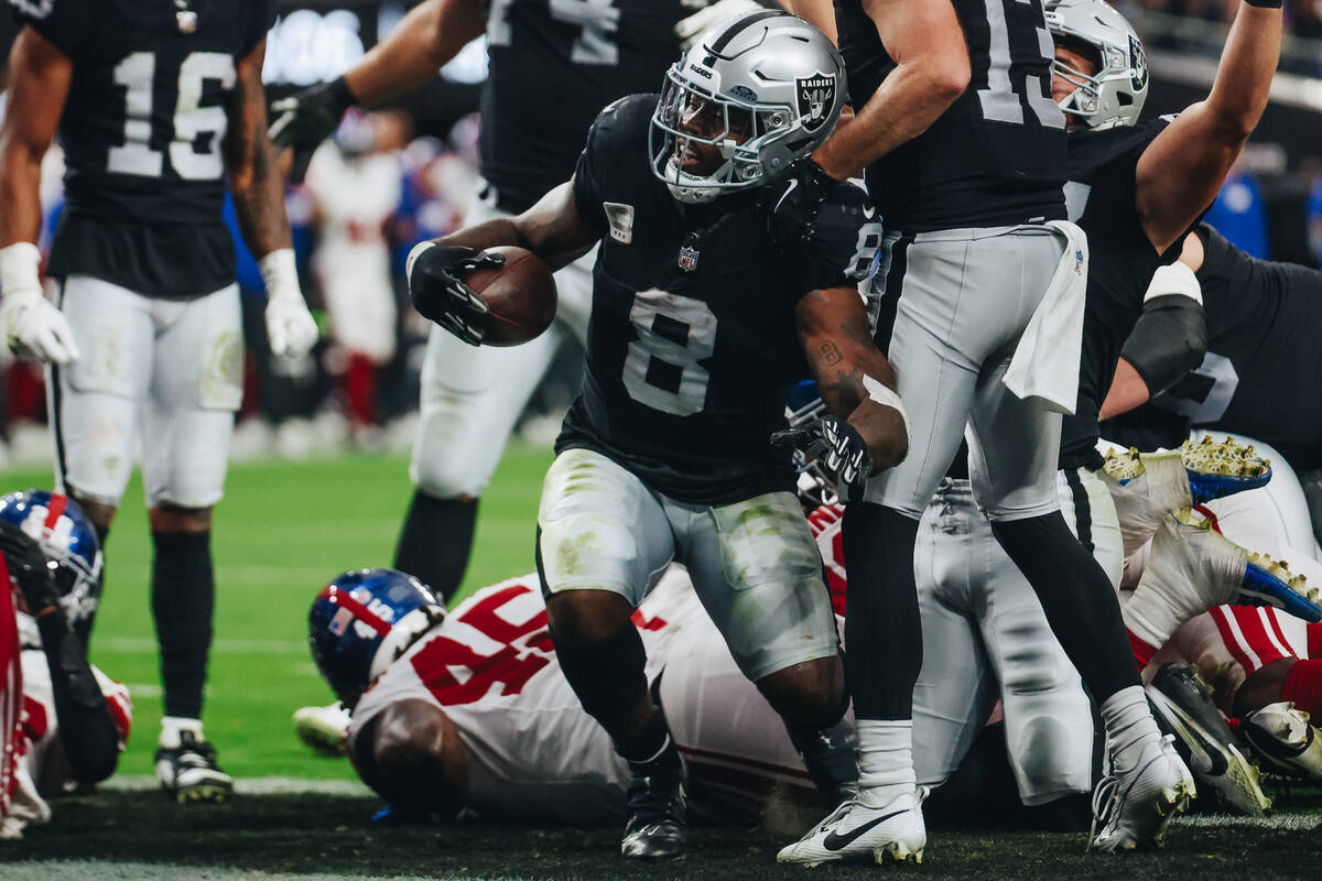 Raiders running back Josh Jacobs (8) makes it into the end zone for a touchdown during the firs ...