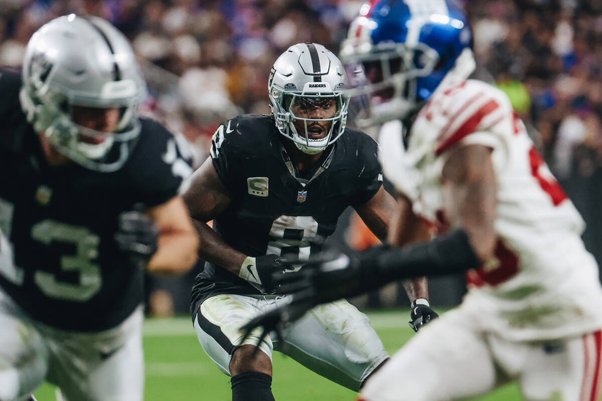 Raiders running back Josh Jacobs (8) looks for an opening during the first half of a game again ...