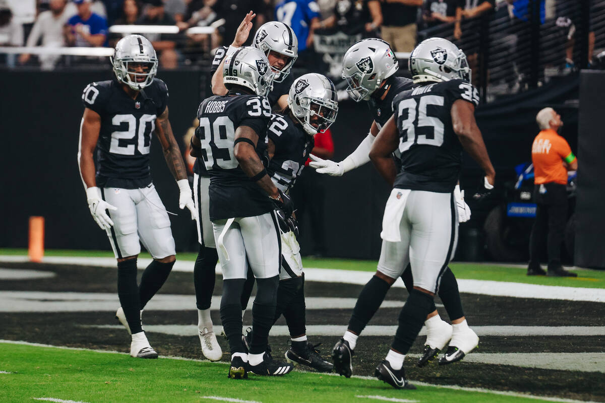 Raiders players celebrate a tackle during the first half of a game against the New York Giants ...