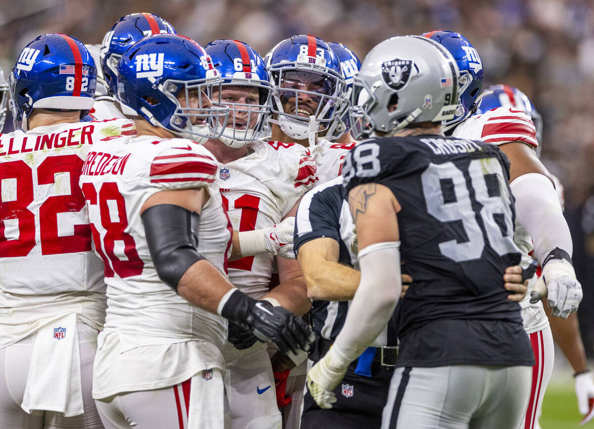 Raiders defensive end Maxx Crosby (98) gets in a verbal argument with the New York Giants offen ...
