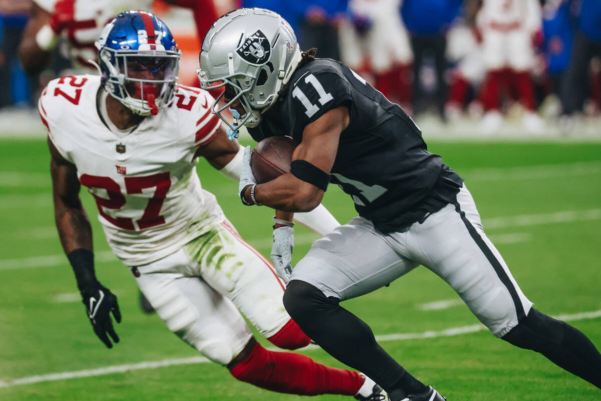 Raiders wide receiver Tre Tucker (11) runs the ball during a game against the New York Giants a ...