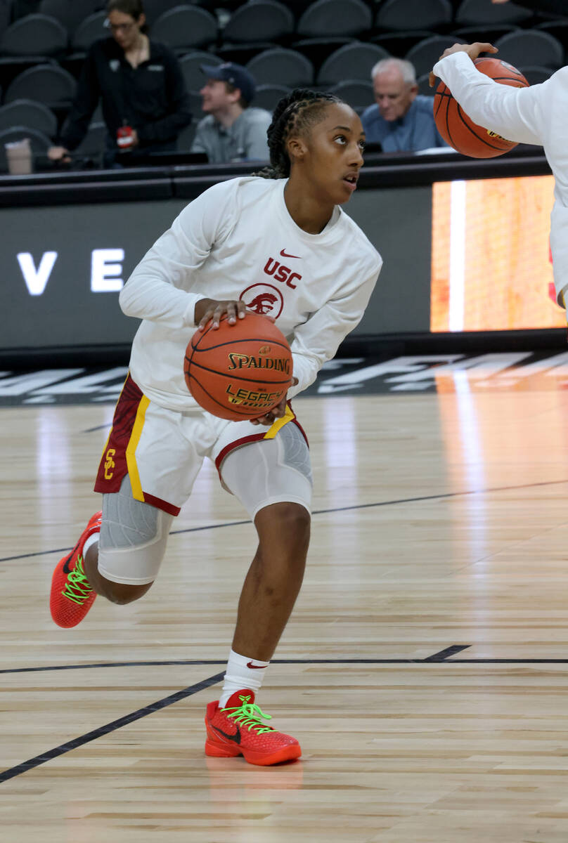 Spring Valley High basketball star Aaliyah Gayles warms up with her USC teammates before the st ...