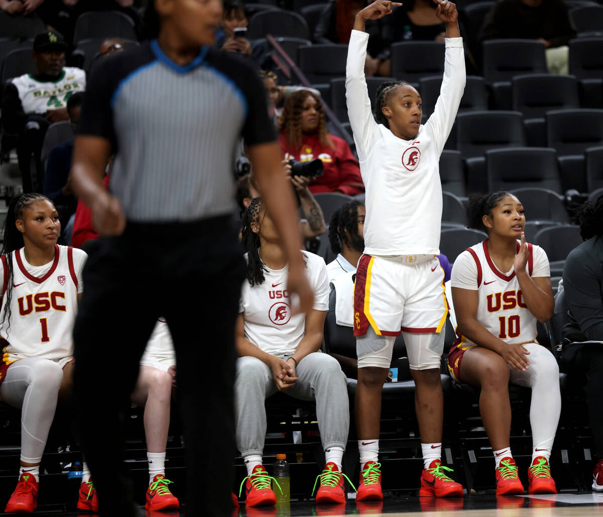 Former Spring Valley High basketball star Aaliyah Gayles, standing, cheers with her USC teammat ...