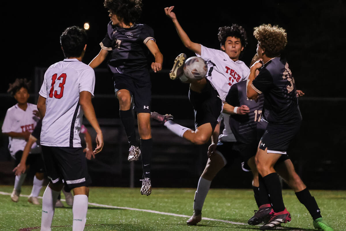 Southeast Career Technical Academy Luis Sarellano-Lopez (11) kicks the ball while midair during ...