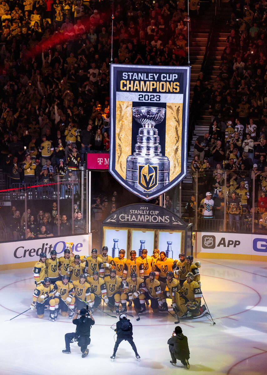 Golden Knights players gather for a group photo during the raising of the 2023 Stanley Cup Cham ...