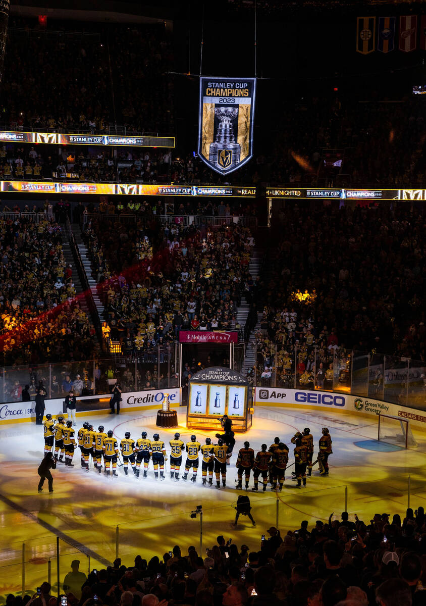 Golden Knights players gather during the raising of the 2023 Stanley Cup Championship banner be ...
