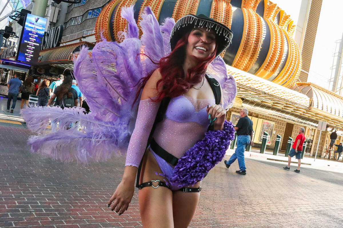 A showgirl battles through the wind along Fremont Street on Monday, Nov. 6, 2023 in Las Vegas. ...
