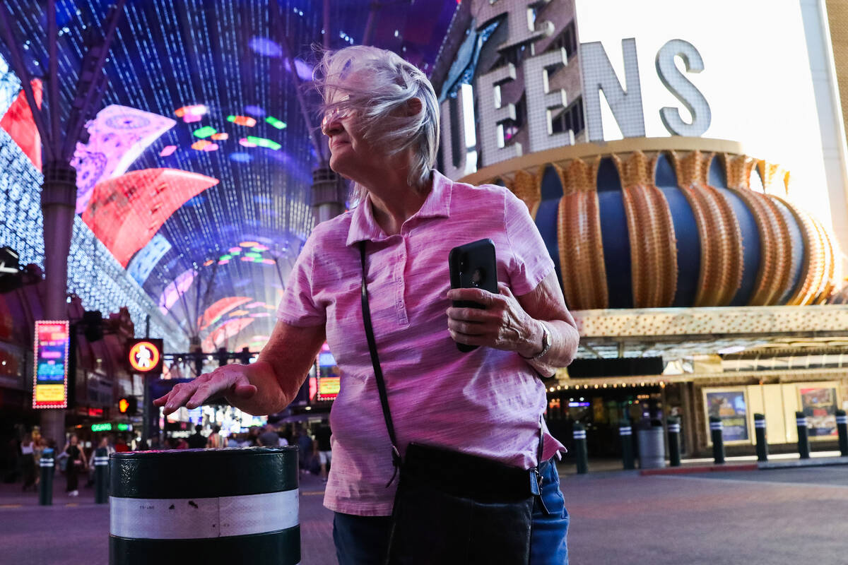 Tourists battle through the wind along Fremont Street on Monday, Nov. 6, 2023 in Las Vegas. (Da ...