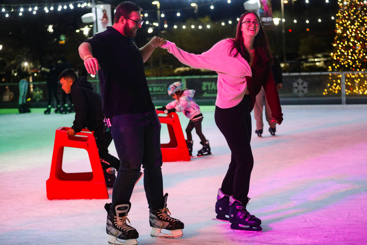 Austin Jacobson ice skates with his girlfriend Cadence Kapeles at the Rock Rink in Downtown Sum ...