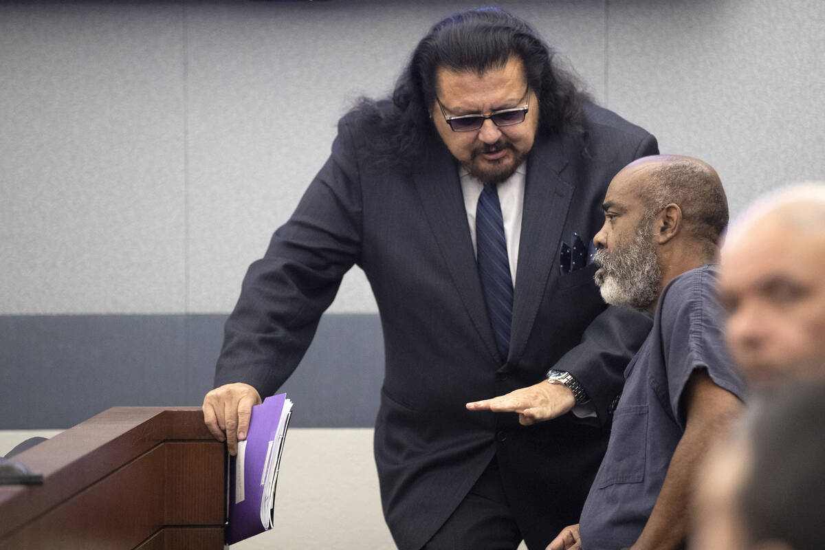 Defense attorney Charles Cano (L) talks with Duane Keith “Keffe D” Davis during a ...
