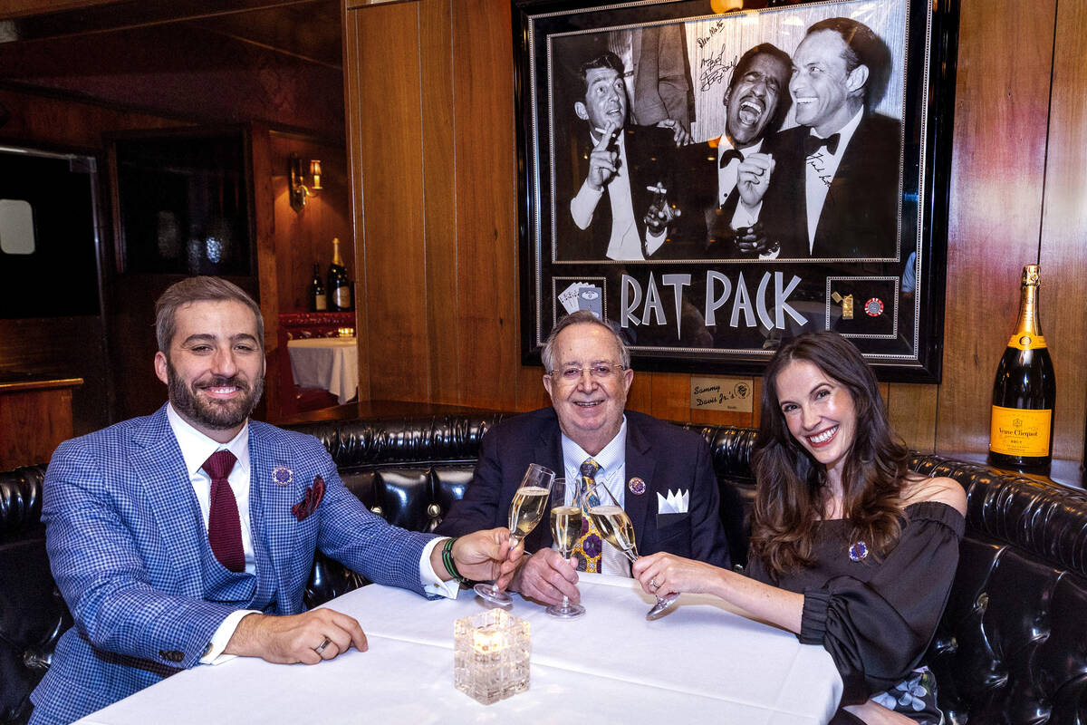 Nick McMillan, Dr. Michael Signorelli, and Amanda Signorelli share a toast during their event t ...