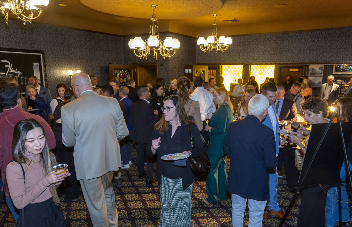 Guests enjoy food and drink in a new room following a ribbon cutting at an event to celebrate t ...
