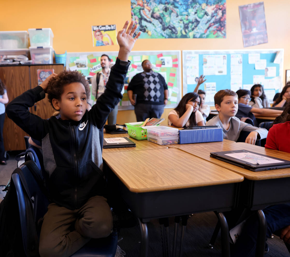 Ortwein Elementary fifth grader Bryson Stanford asks a question during a fellow student’ ...
