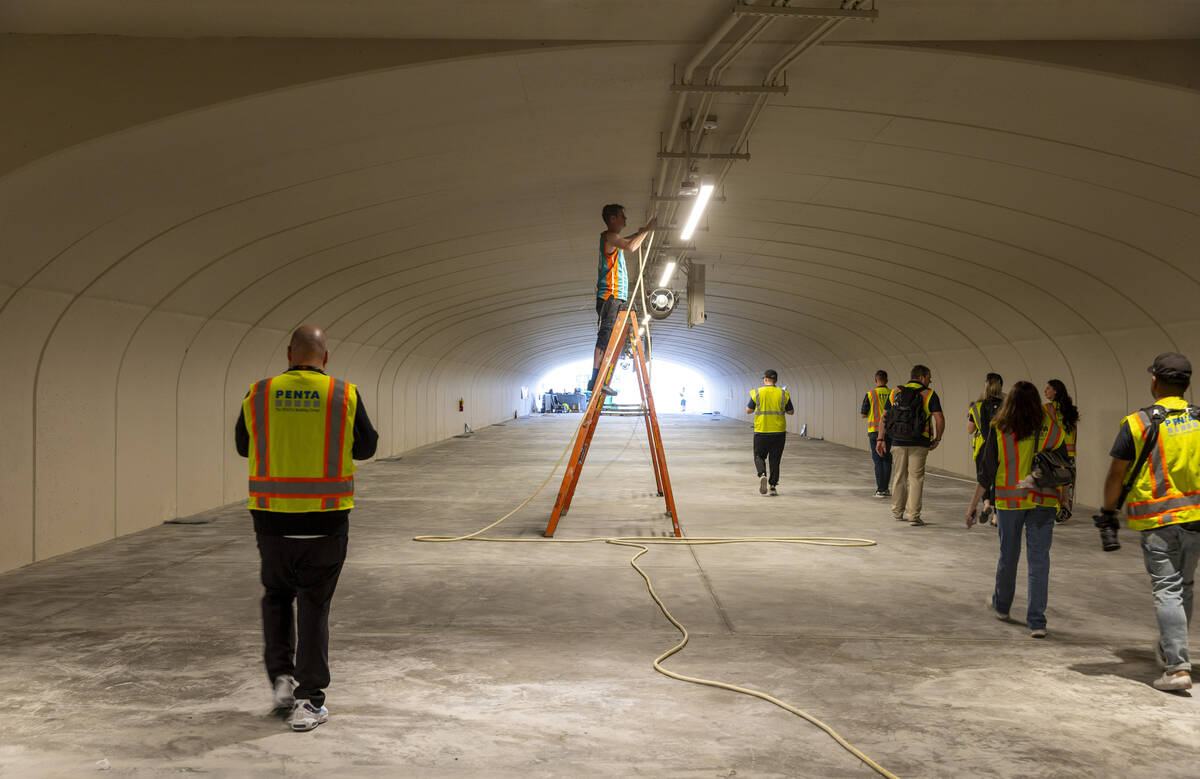 Light panels are hung within one of several tunnels beneath the track as construction continues ...