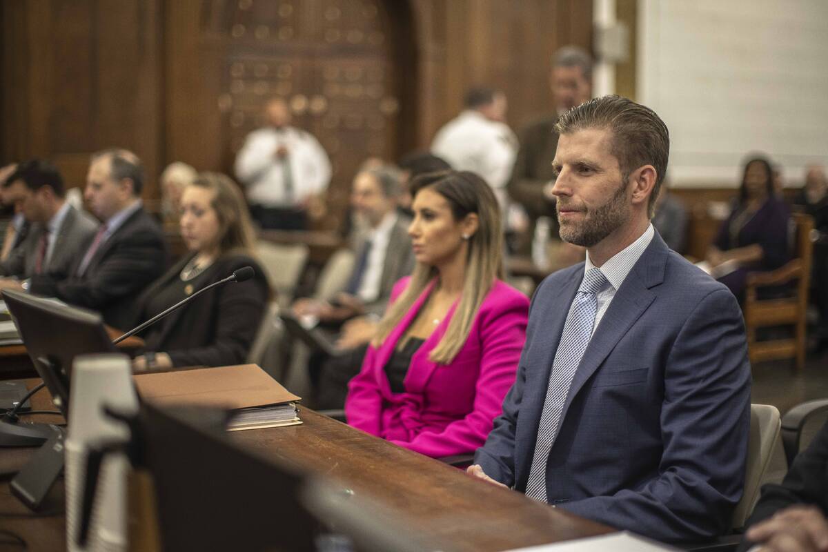 Eric Trump, son of former President Donald Trump, second from left, is seated ahead of his seco ...