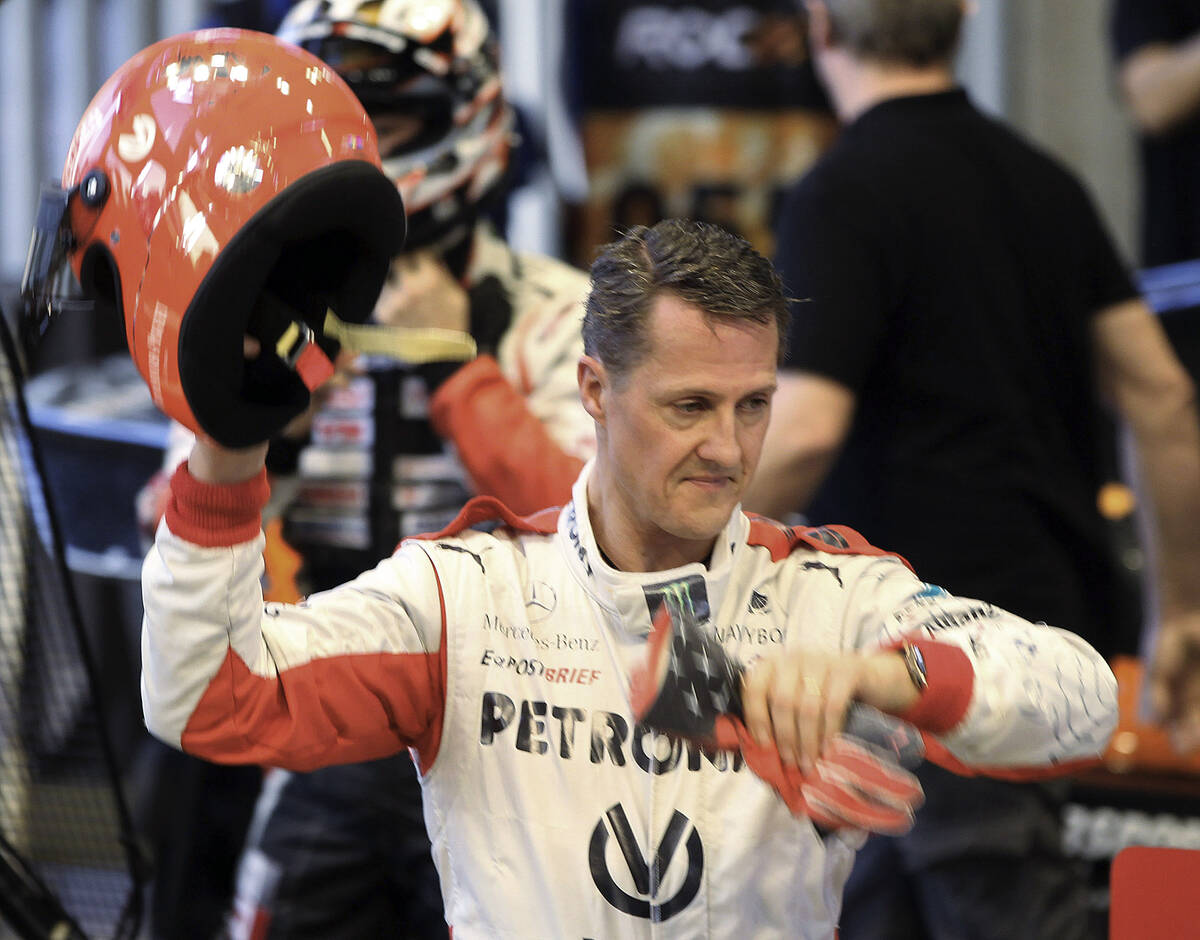 Michael Schumacher of Germany holds a helmet after a test drive prior to the Race Of Champions ...