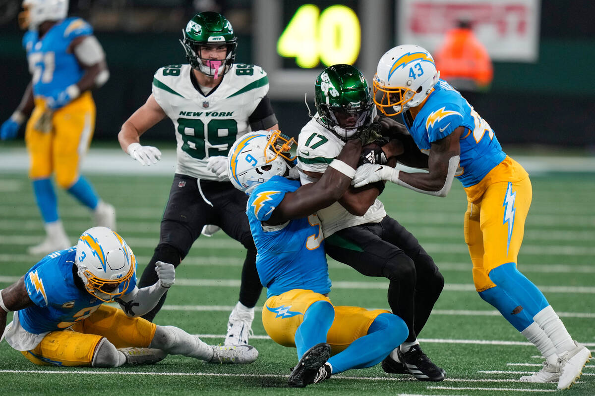 New York Jets wide receiver Garrett Wilson (17) is tackled by Los Angeles Chargers linebacker K ...