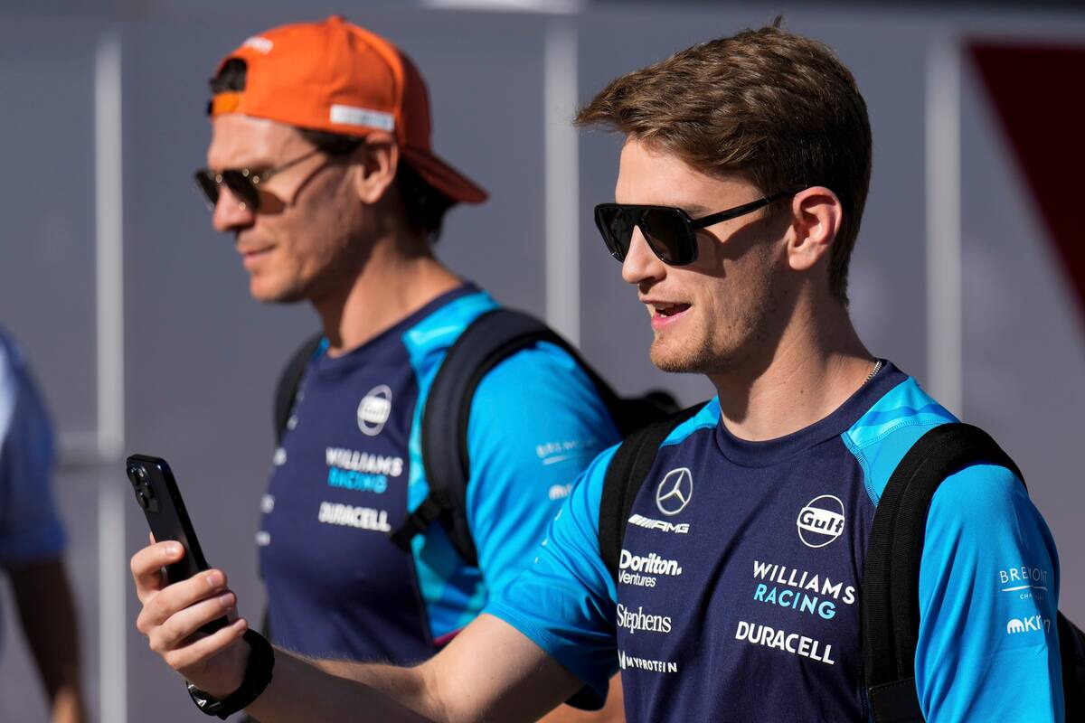 Williams driver Logan Sargeant of the United States talks on his phone in the paddock ahead of ...
