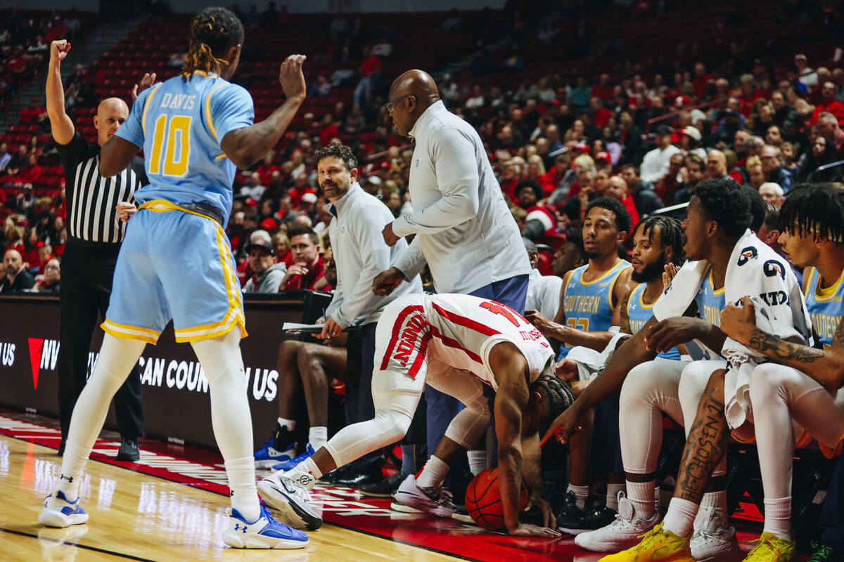 UNLV guard Jackie Johnson III (24) falls into the Southern bench after running out of bounds wi ...