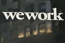 The WeWork logo appears on a building exterior in New York on Tuesday, Nov. 7, 2023. (AP Photo/ ...
