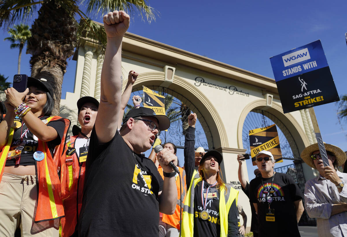 SAG-AFTRA chief negotiator Duncan Crabtree-Ireland, left, rallies striking actors in outside Pa ...