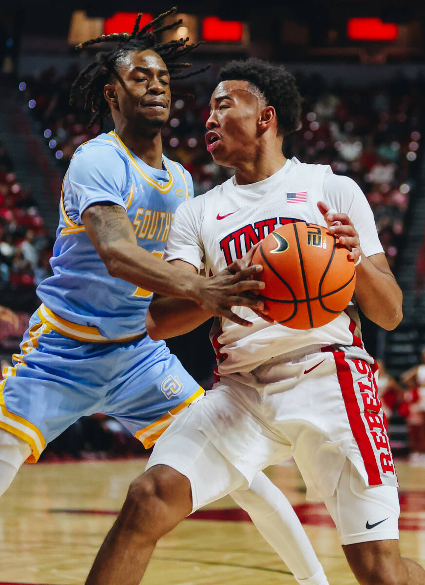 UNLV guard Dedan Thomas Jr. (11) fights to keep the ball in his grip during a game against Sout ...