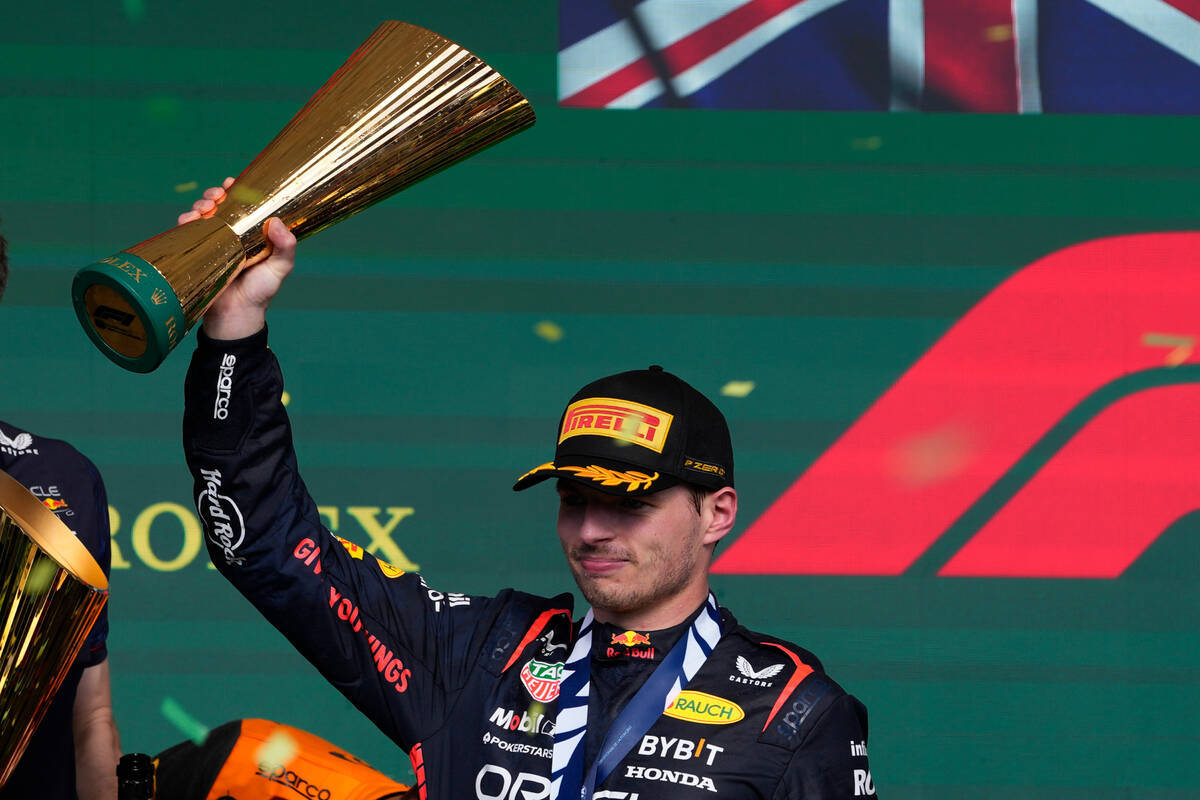 Red Bull driver Max Verstappen of the Netherlands celebrates at the podium after winning the Br ...