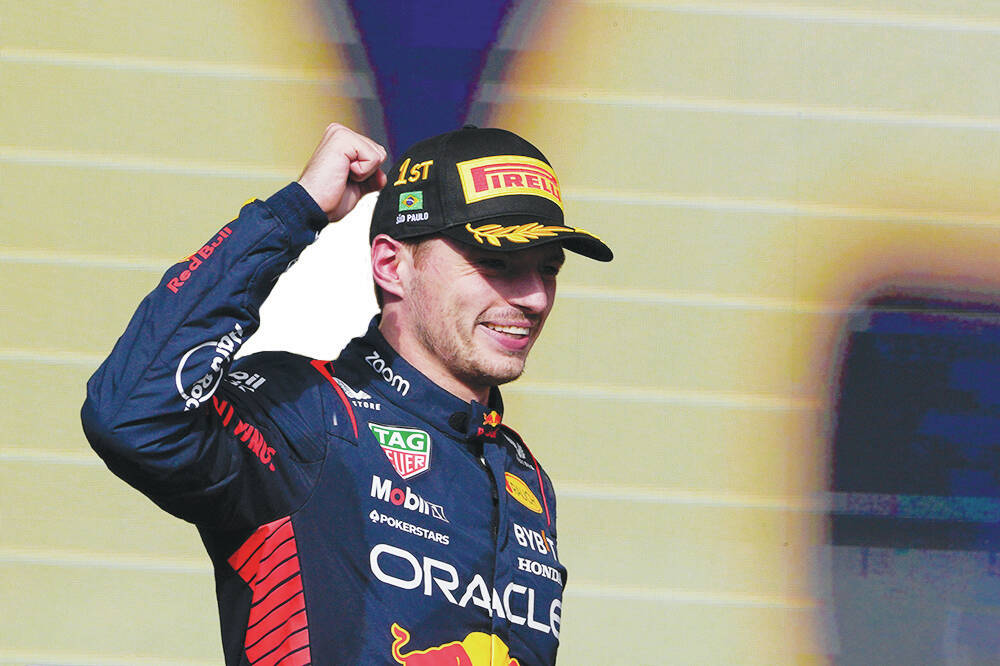 Red Bull driver Max Verstappen of the Netherlands celebrates his first place on the podium at t ...