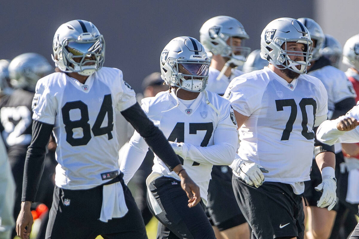 Raiders running back Sincere McCormick (47) runs between wide receiver Keelan Cole Sr. (84) and ...