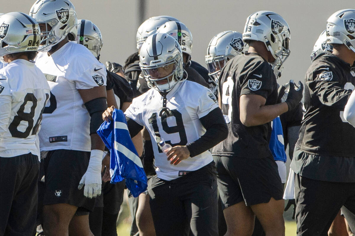 Raiders wide receiver DJ Turner (19) grabs a scout team jersey during practice at the Intermoun ...