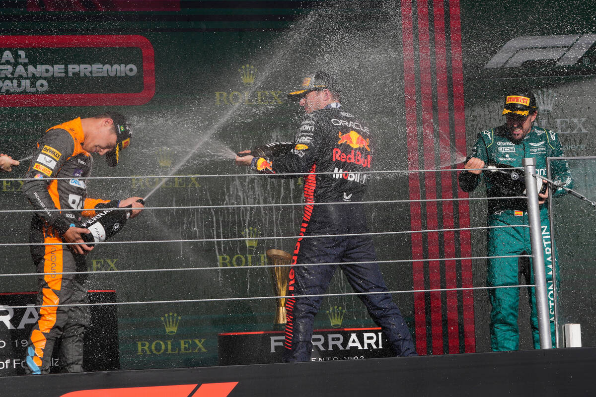 Winner Red Bull driver Max Verstappen of the Netherlands, center, sprays champagne on the podiu ...