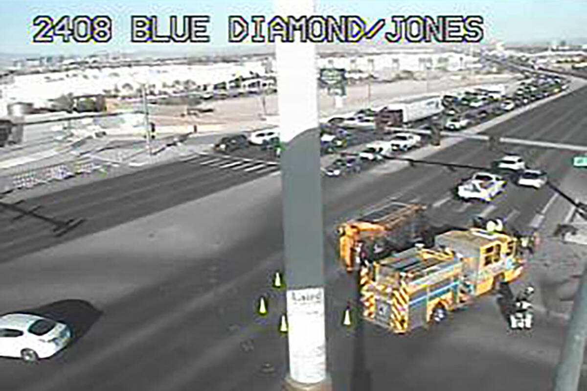A school bus rests on its side aftercolliding with an SUV at Blue Diamond Road and South Jones ...
