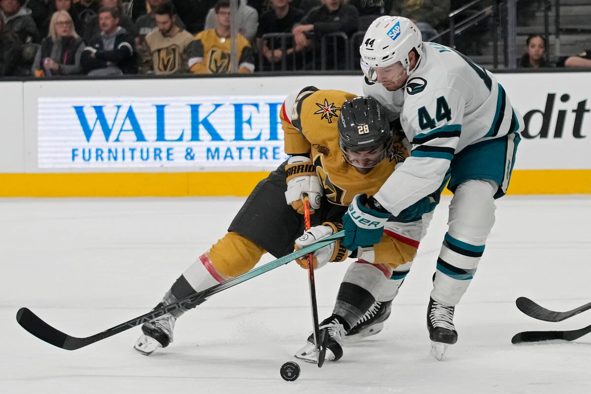 Vegas Golden Knights left wing William Carrier (28) vies for the puck with San Jose Sharks defe ...