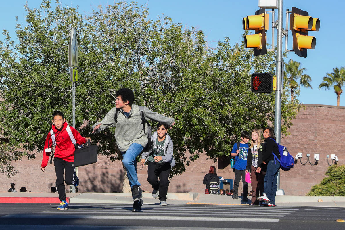 Middle School children cross Valle Verde Drive as they leave Greenspun Junior High School on Th ...