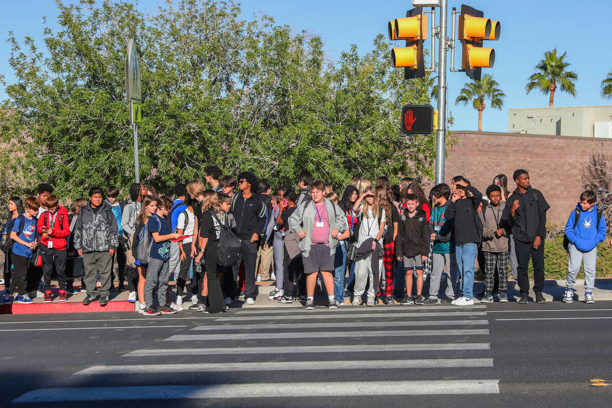 Middle School children prepare to cross Valle Verde Drive as they leave Greenspun Junior High S ...