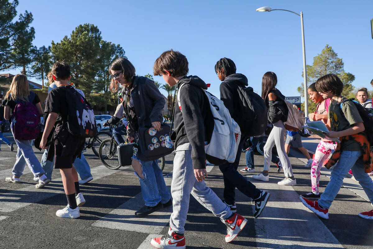 Middle School children cross Valle Verde Drive as they leave Greenspun Junior High School on Th ...