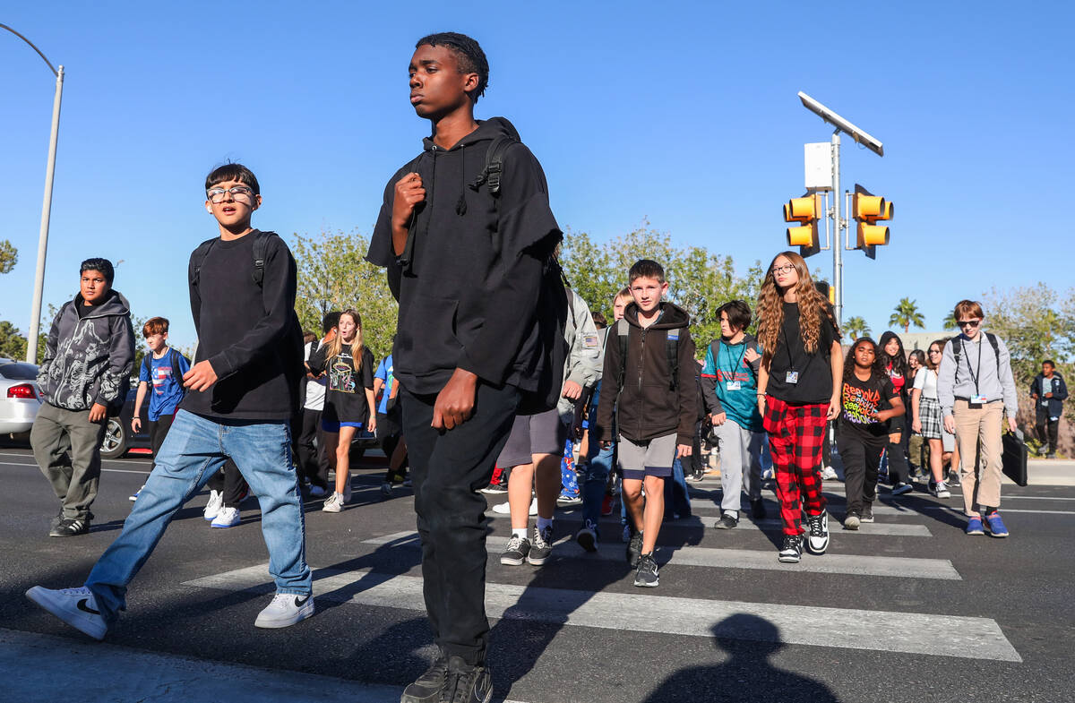 Middle School children cross Valle Verde Drive as they leave Greenspun Junior High School on Th ...
