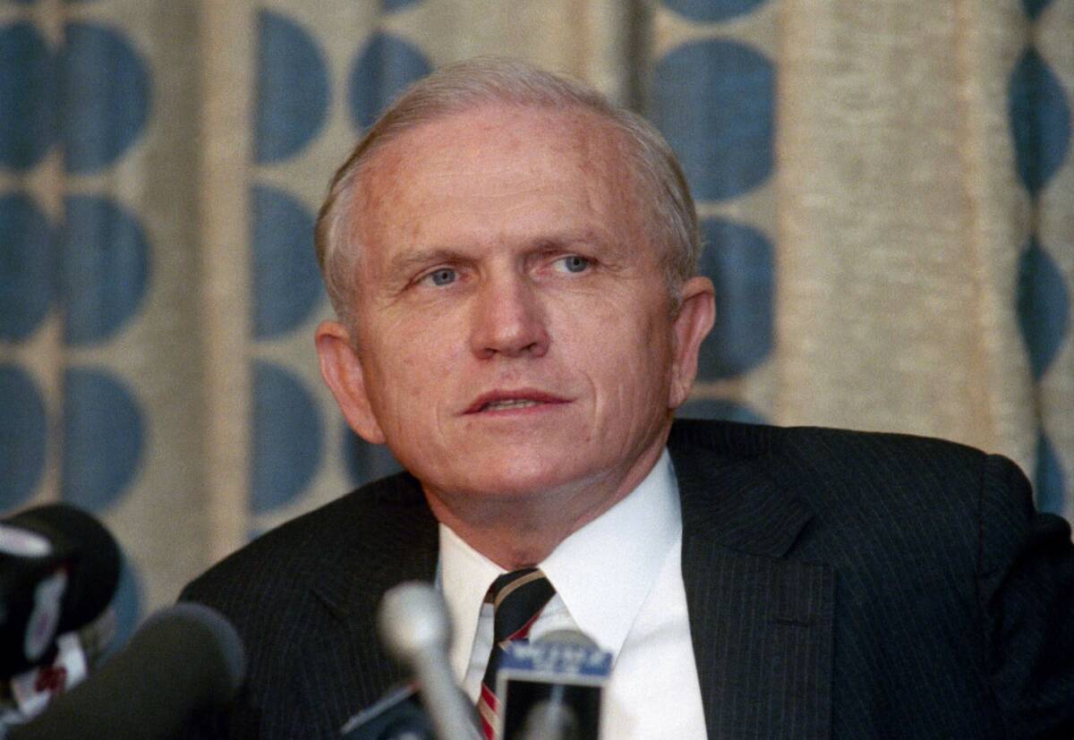 Frank Borman ponders a question at news conference in Miami, June 3, 1986. (AP Photo/Doug Jennings)