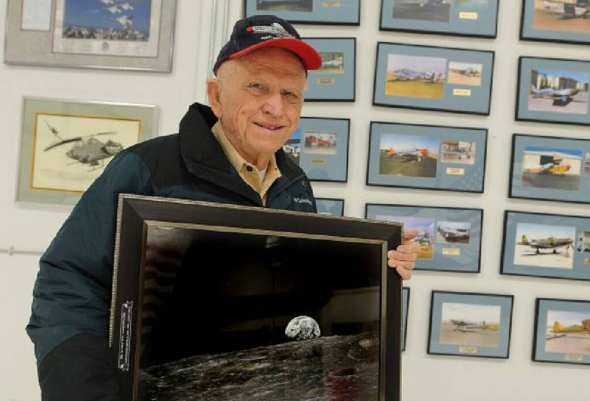 Apollo 8 Commander Frank Borman poses in Billings, Mont, with a photograph of Earth taken as hi ...