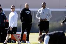 Raiders head coach Antonio Pierce, left, observes practice with defensive coordinator Patrick G ...
