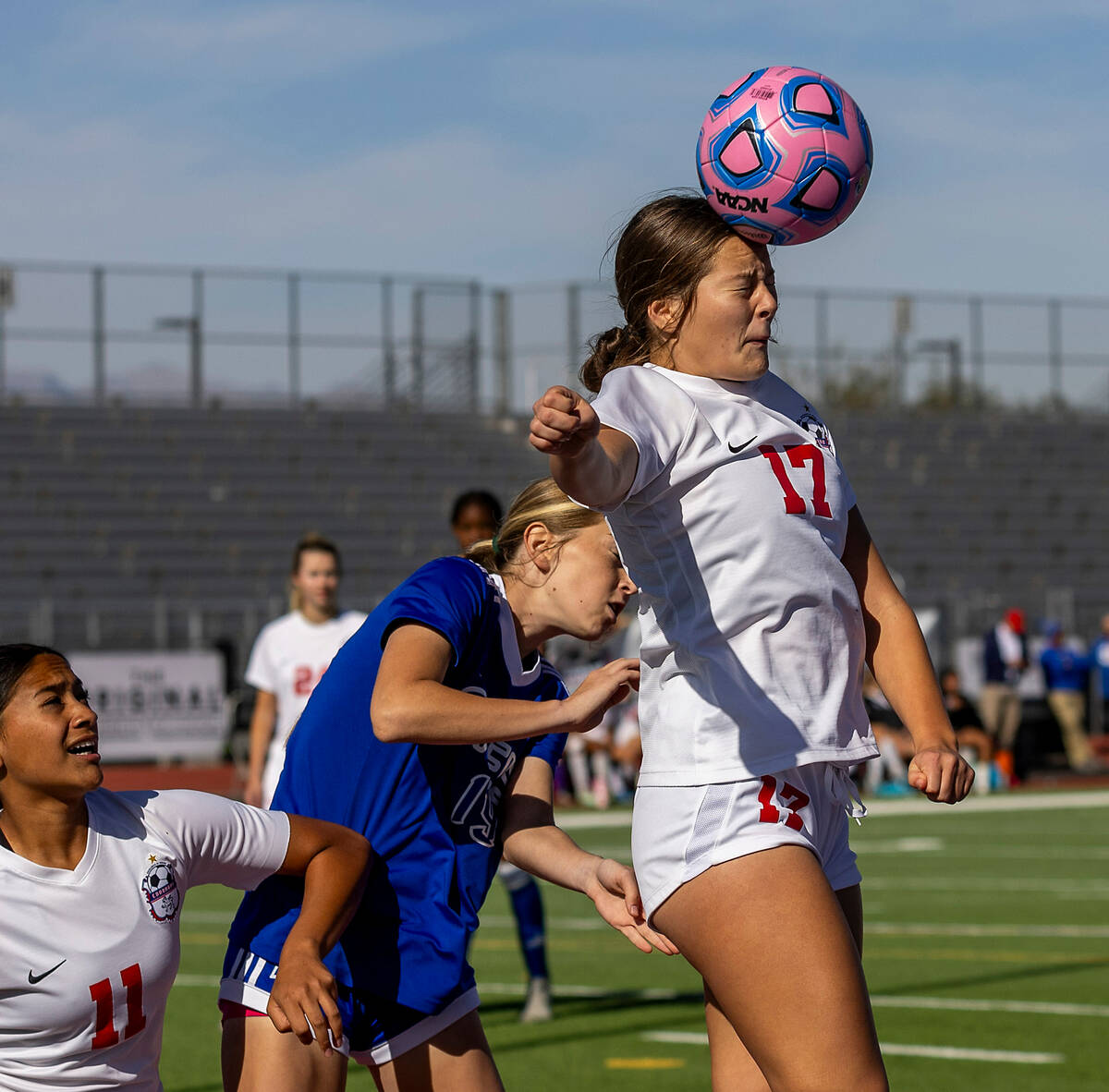 Coronado defender Ella Schultz (17) heads the ball over Bishop Gorman defender Riley Rohr (19) ...