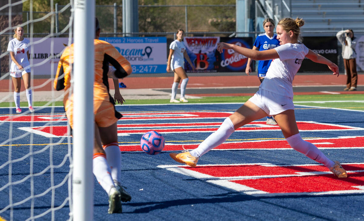 Coronado midfielder Ryan Neel (9) kicks a goal shot past Bishop Gorman goalkeeper Laila Lazzara ...