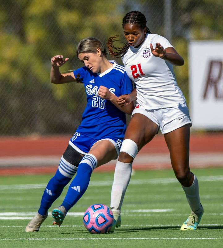 Bishop Gorman defender Tatum Manley (26) battles for control of the ball with Coronado midfiel ...