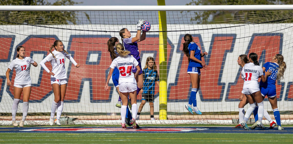 Coronado goalkeeper Megan Kingman (0) elevates to grab a header attempt from Bishop Gorman forw ...